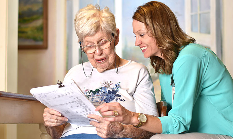 Doctor helping patient fill out forms